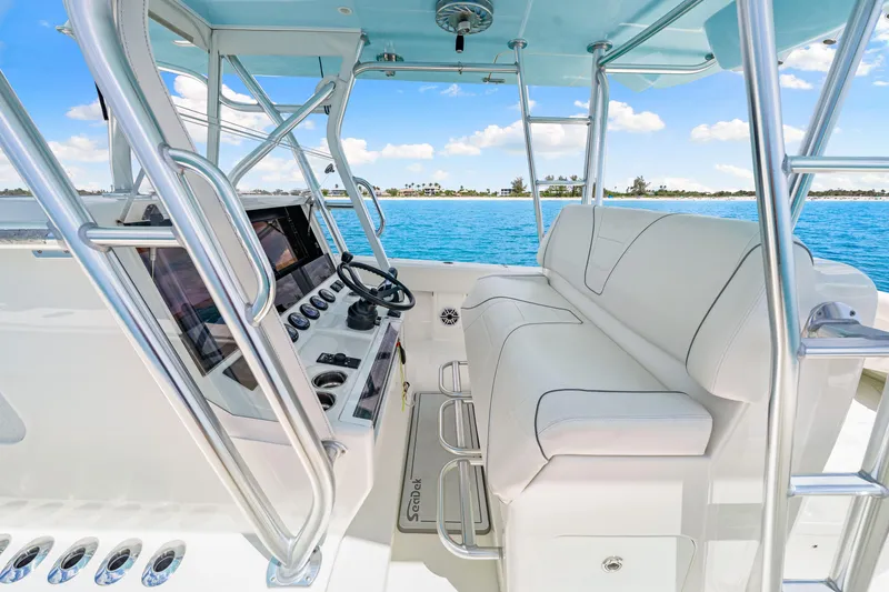 Slide: The Image of 2021 SeaVee 390B boat interior with helm, white seating, and ocean view. - 43
