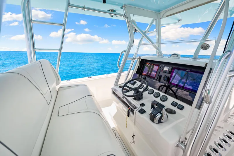 Slide: The Image of 2021 SeaVee 390B boat cockpit with modern controls and ocean view. - 44