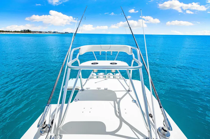 Slide: The Image of 2021 SeaVee 390B boat with fishing rods on a calm ocean, clear blue sky. - 49