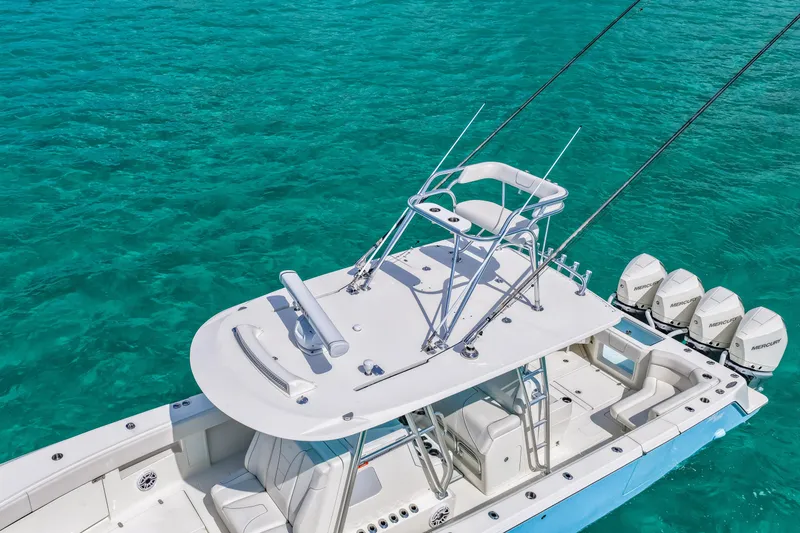 Slide: The Image of 2021 SeaVee 390B boat with multiple outboard engines on clear turquoise water. - 5