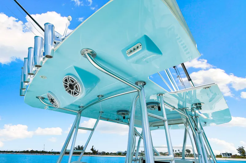 Slide: The Image of 2021 SeaVee 390B boat with sleek design, stainless steel fixtures, and vibrant blue sky backdrop. - 54