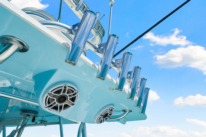 Slide: The Image of 2021 SeaVee 390B boat detail with rod holders and speakers against blue sky. - 55