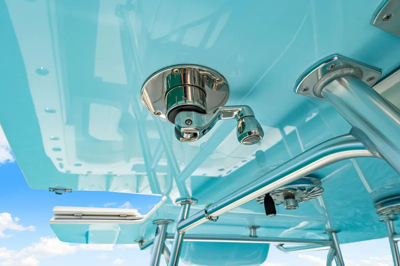 Slide: The Image of 2021 SeaVee 390B boat detail, featuring polished metal fixtures and blue canopy against a clear sky. - 57