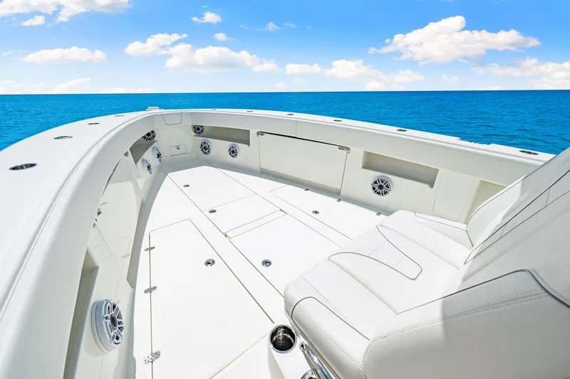 Slide: The Image of 2021 SeaVee 390B boat deck with ocean view, featuring spacious seating and storage. - 58