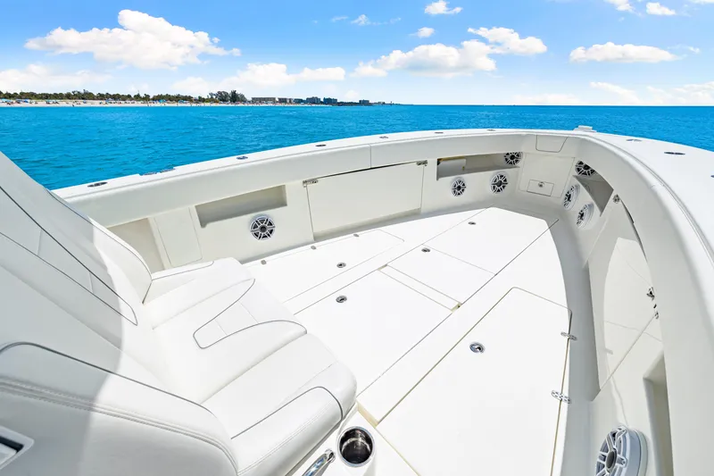 Slide: The Image of 2021 SeaVee 390B boat deck with white seating, ocean view, and clear blue sky. - 59