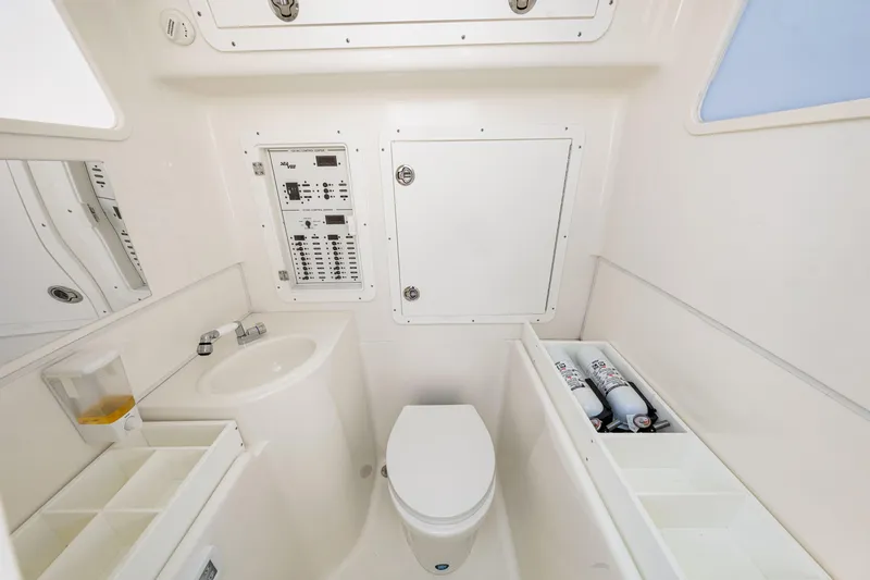 Slide: The Image of 2021 SeaVee 390B boat bathroom with sink, toilet, and storage compartments. - 63