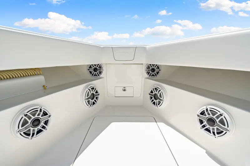 Slide: The Image of 2021 SeaVee 390B boat interior with multiple speakers, under a clear blue sky. - 64