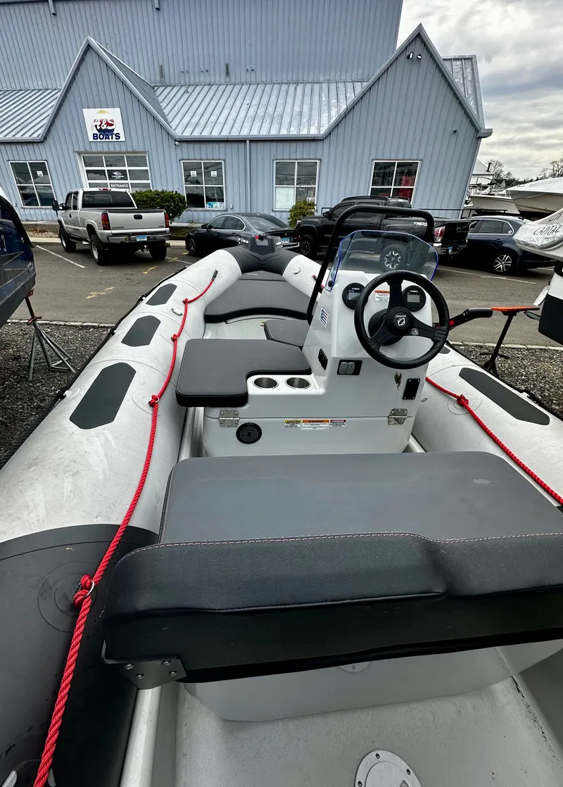 Slide: The Image of Zodiac Open 4.8 boat 2023 in front of a blue building. - 8