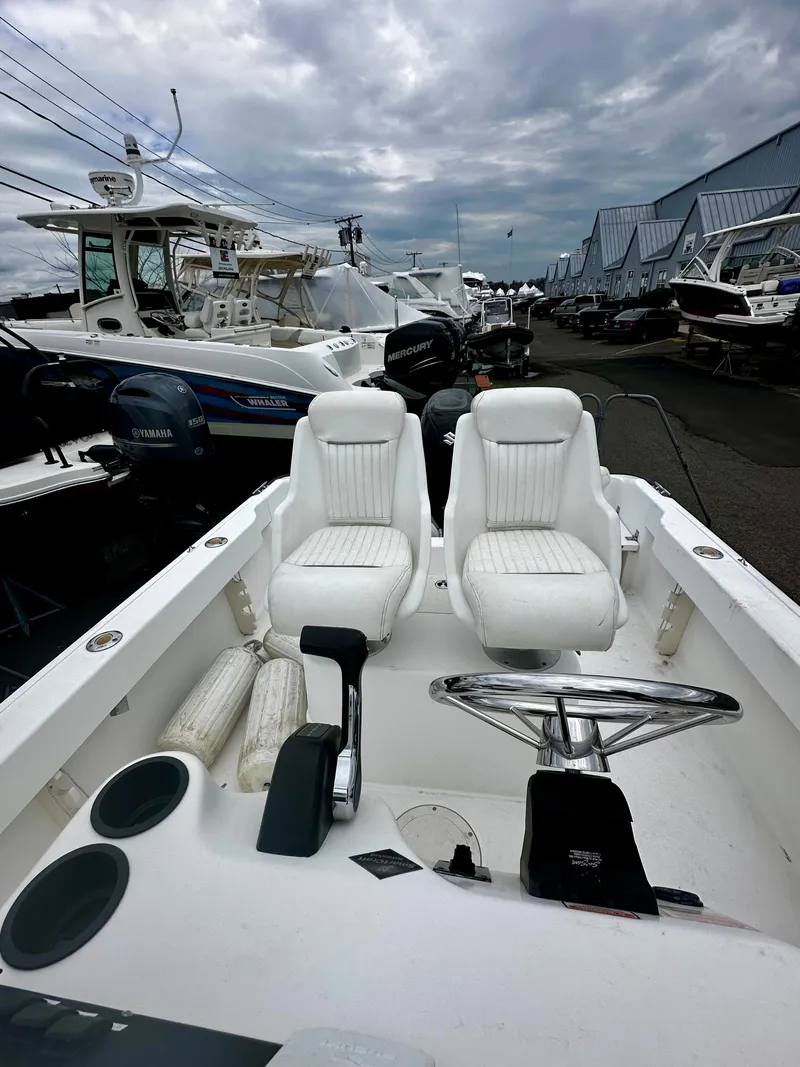 Slide: The Image of Interior view of a 2004 Boston Whaler 190 Nantucket boat at the marina. - 10