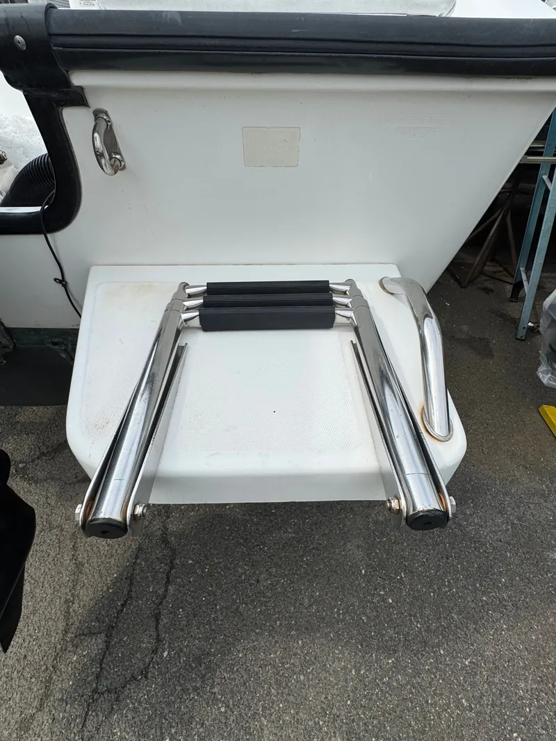 Slide: The Image of 2004 Boston Whaler 190 Nantucket boat ladder, stainless steel, on asphalt. - 23