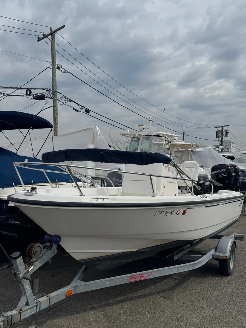 Slide: The Image of 2004 Boston Whaler 190 Nantucket on trailer, cloudy sky. - 26