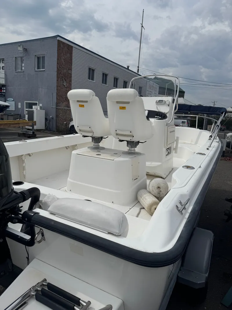 Slide: The Image of 2004 Boston Whaler 190 Nantucket boat with dual seats in harbor. - 31