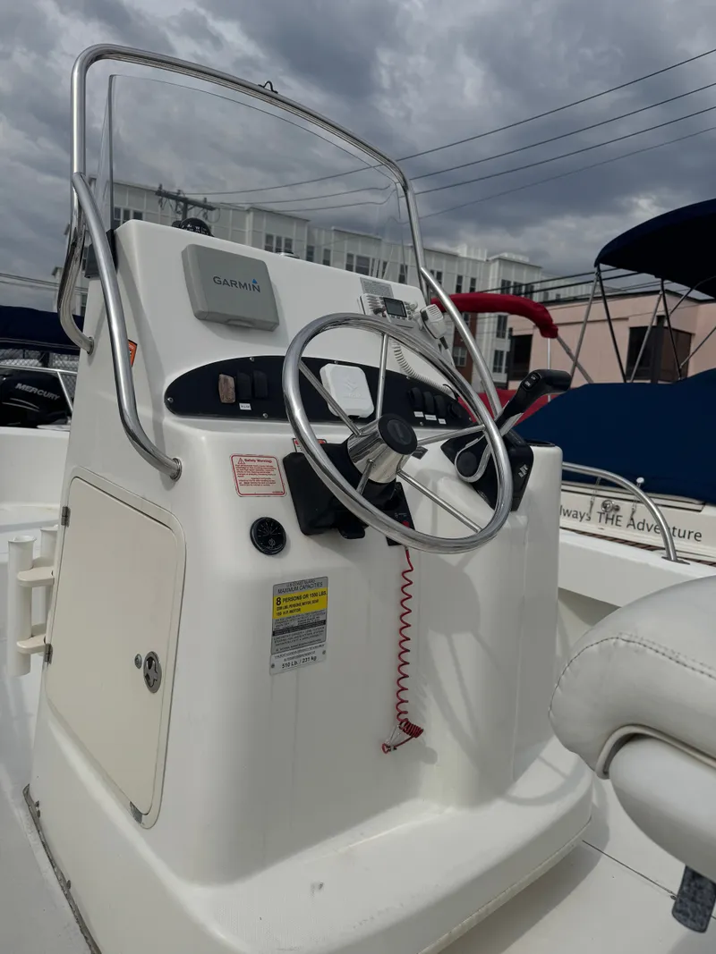 Slide: The Image of Steering console of a 2004 Boston Whaler 190 Nantucket boat. - 32