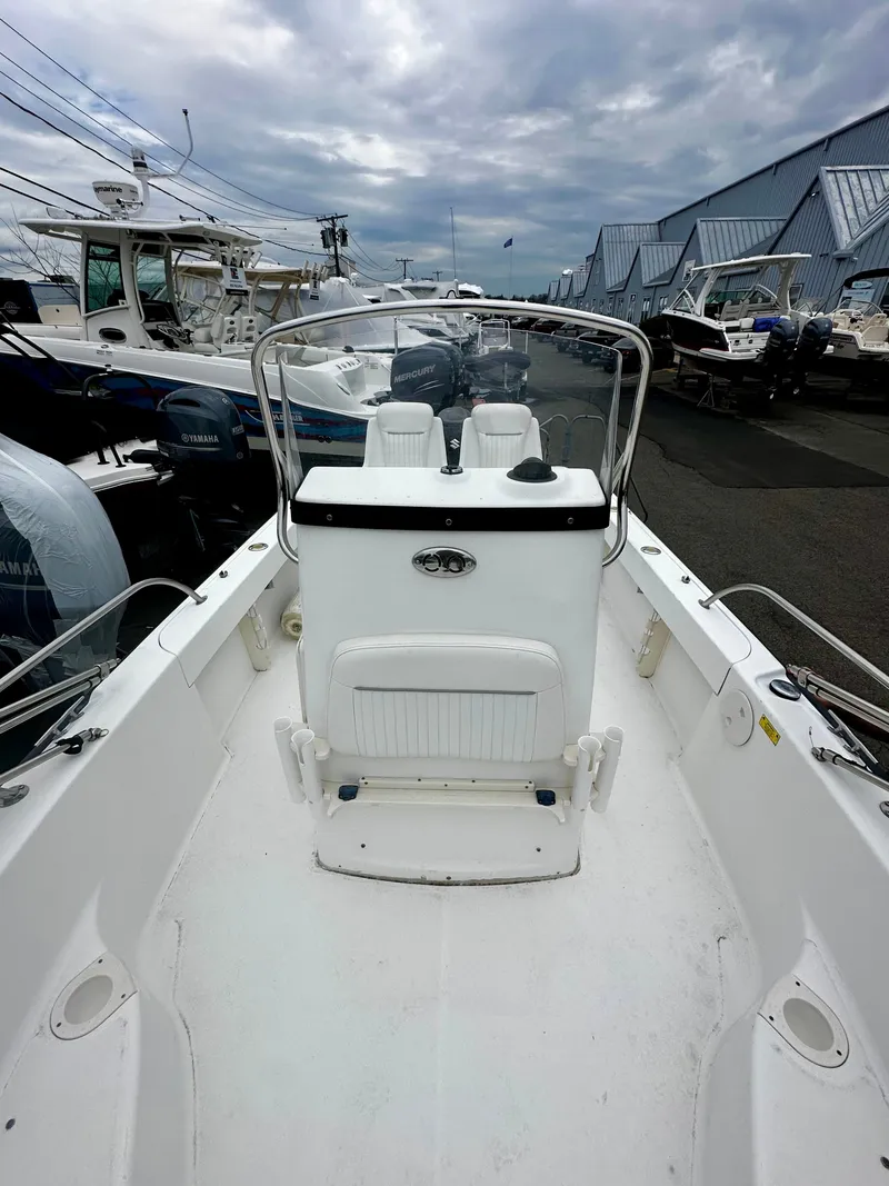 Slide: The Image of Boston Whaler 190 Nantucket 2004 boat at a dock under cloudy skies. - 6