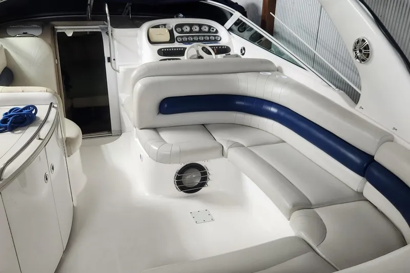 Slide: The Image of 2002 Powerquest 320 SC boat interior with white and blue seating, sleek dashboard, and modern design. - 3