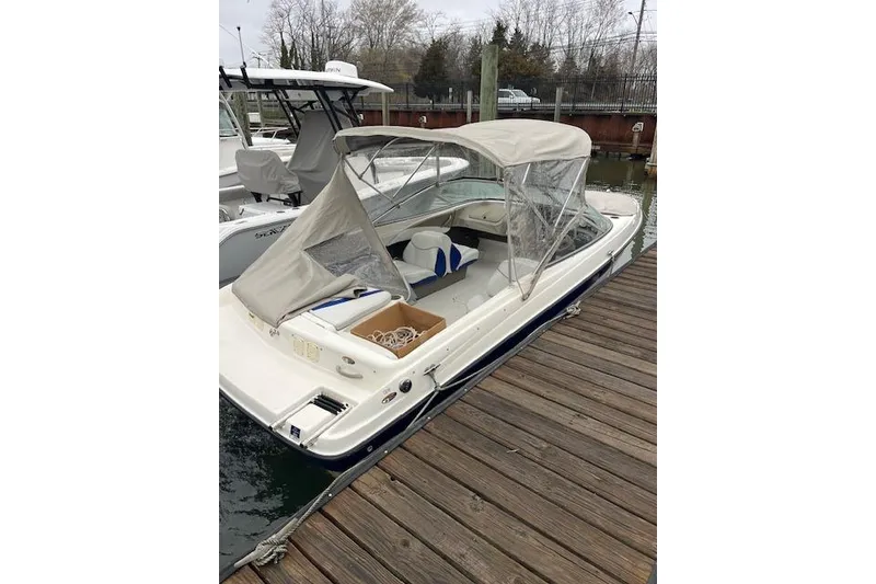 Slide: The Image of 2003 Bayliner 205 Classic boat docked with canopy and seating visible. - 3