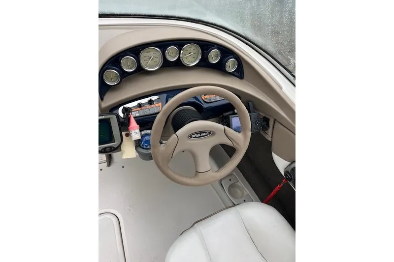 Slide: The Image of Steering wheel and dashboard of a 2003 Bayliner 205 Classic boat. - 4
