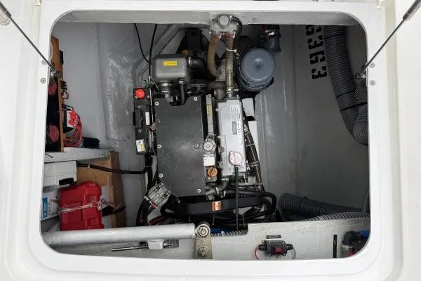 Slide: The Image of Engine compartment of a 2018 Lagoon 42 catamaran, showcasing mechanical components and storage. - 10