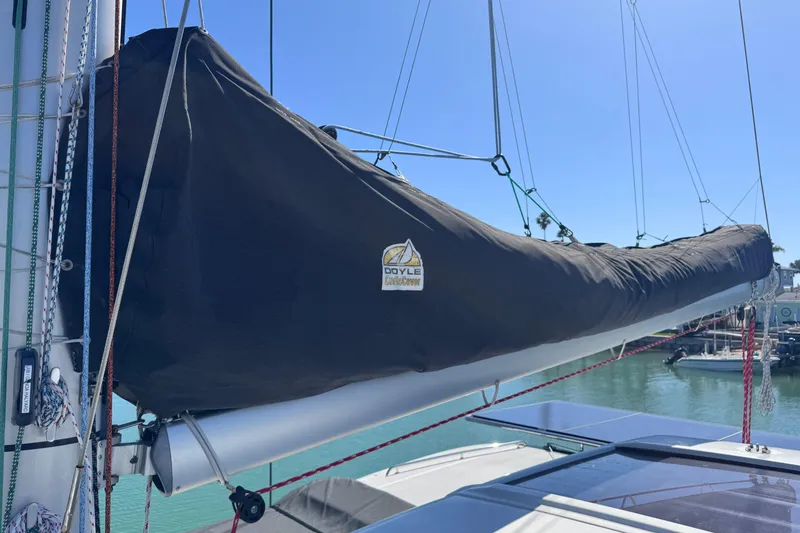 Slide: The Image of 2018 Lagoon 42 sailboat with Doyle sail cover, docked in sunny marina. - 16
