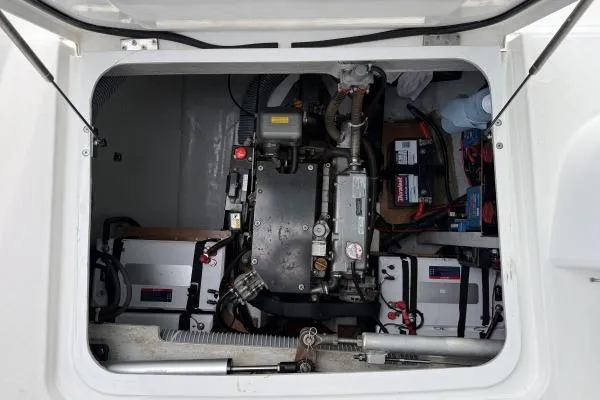 Slide: The Image of Engine compartment of a 2018 Lagoon 42 catamaran, showcasing mechanical components and batteries. - 19