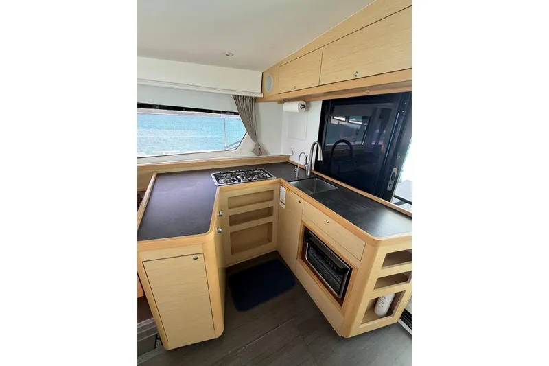 Slide: The Image of Modern kitchen interior of 2018 Lagoon 42 catamaran with stove, sink, and oven. - 5