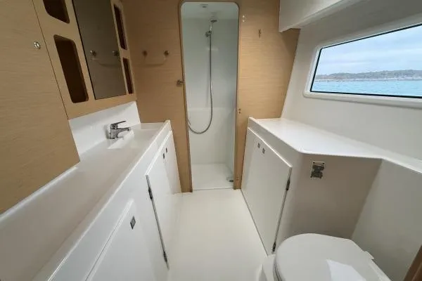 Slide: The Image of Luxurious bathroom interior of 2018 Lagoon 42 catamaran with modern fixtures and ocean view. - 7