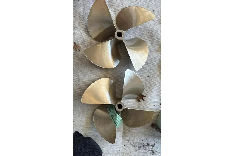 Slide: The Image of Two brass boat propellers on a textured surface, suitable for a 1986 Topaz 32 Express. - 4