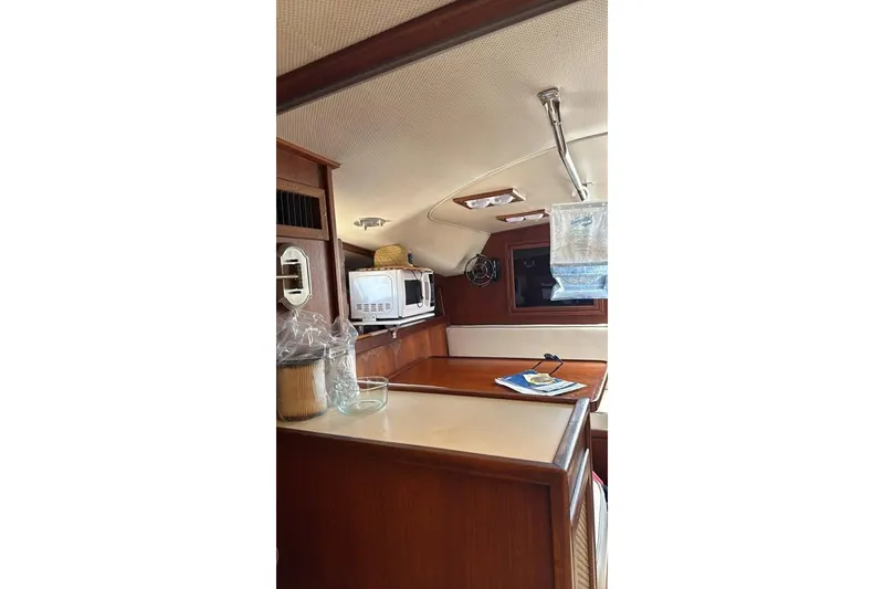 Slide: The Image of Interior of 1986 Topaz 32 Express boat with kitchen and dining area. - 8