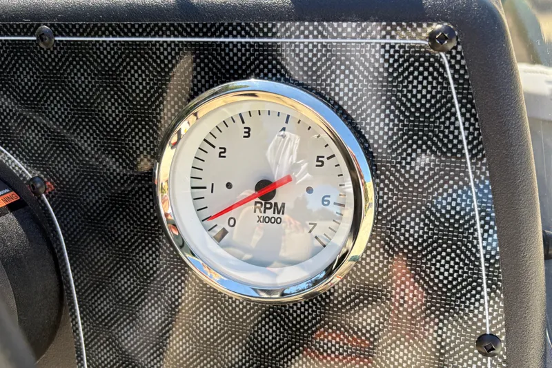 Slide: The Image of Tachometer on 2026 Tracker Bass Tracker Classic Limited boat dashboard, carbon fiber background. - 19
