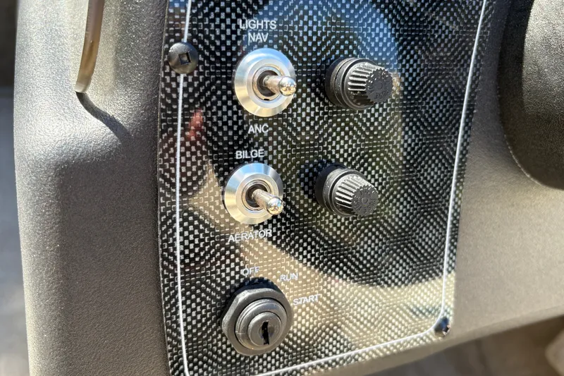 Slide: The Image of Control panel of 2026 Tracker Bass Tracker Classic Limited boat with switches and knobs. - 20