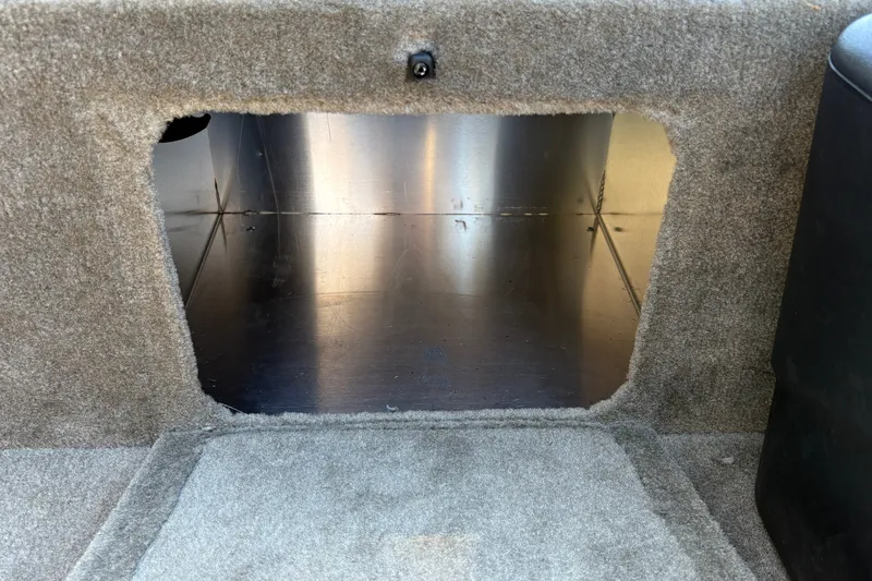 Slide: The Image of Interior compartment of 2026 Tracker Bass Tracker Classic Limited boat, featuring carpeted finish. - 26