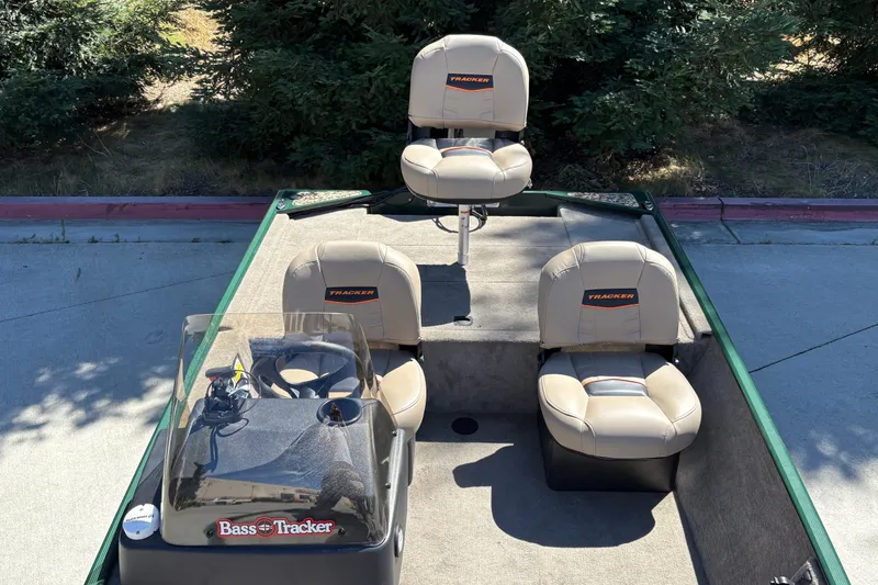 Slide: The Image of 2026 Tracker Bass Tracker Classic Limited boat interior with beige seats and steering console. - 16