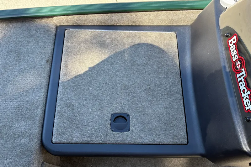 Slide: The Image of 2026 Tracker Bass Tracker Classic Limited boat deck with carpeted storage compartment. - 24