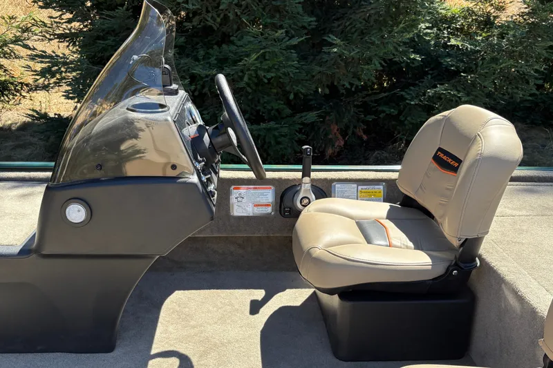 Slide: The Image of 2026 Tracker Bass Tracker Classic Limited boat interior with steering wheel and seat. - 17