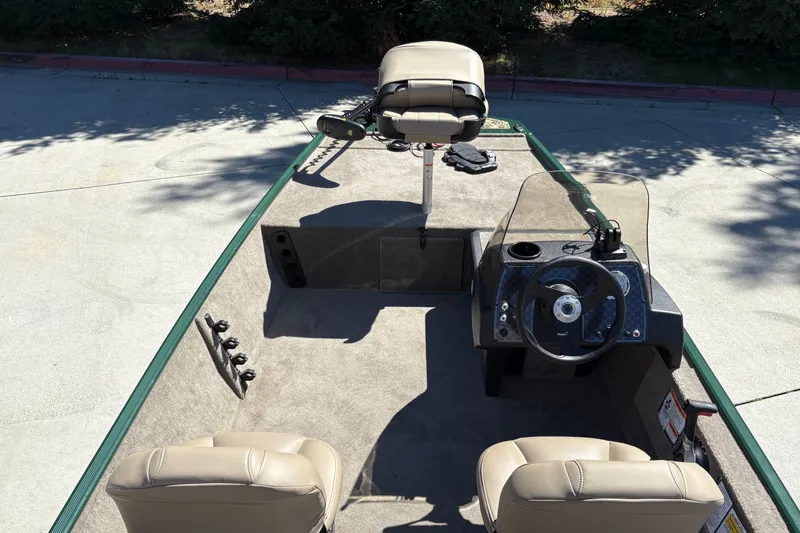 Slide: The Image of 2026 Tracker Bass Tracker Classic Limited boat interior with steering console and seating. - 18