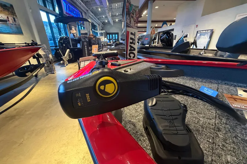 Slide: The Image of 2026 Tracker Pro Team 175 Crappie Edition boat displayed in showroom with Minn Kota motor. - 6