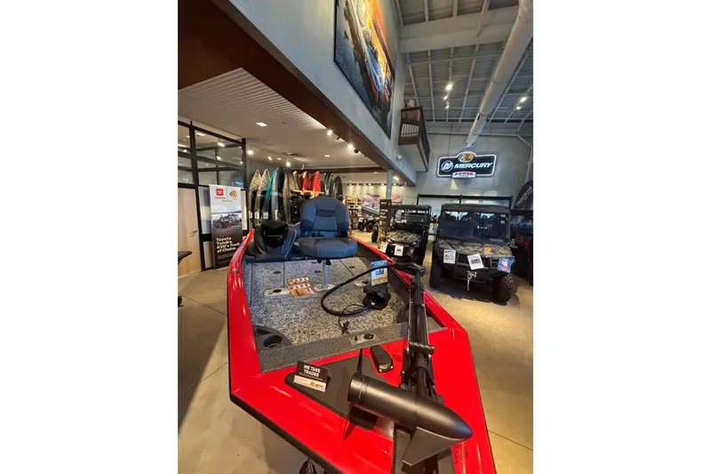 Slide: The Image of 2026 Tracker Pro Team 175 Crappie Edition boat displayed in showroom with fishing gear. - 7