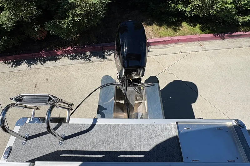 Slide: The Image of 2026 Sun Tracker Bass Buggy 16 XL Select pontoon boat with motor and ladder, top view. - 24