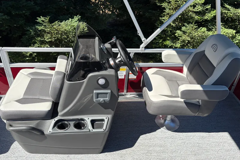 Slide: The Image of 2026 Sun Tracker Bass Buggy 16 XL Select boat interior with dual captain chairs and steering console. - 21