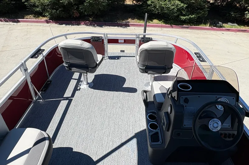 Slide: The Image of 2026 Sun Tracker Bass Buggy 16 XL Select pontoon boat interior with seating and steering console. - 19
