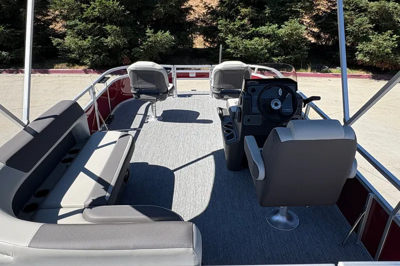 Slide: The Image of 2026 Sun Tracker Bass Buggy 16 XL Select pontoon boat interior with seating and steering console. - 23