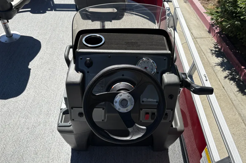 Slide: The Image of 2026 Sun Tracker Bass Buggy 16 XL Select steering console with cup holder and gauges. - 22