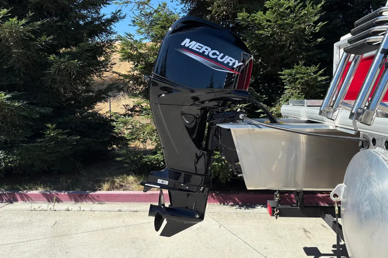 Slide: The Image of 2026 Sun Tracker Bass Buggy 16 XL Select with Mercury outboard motor, parked outdoors. - 37
