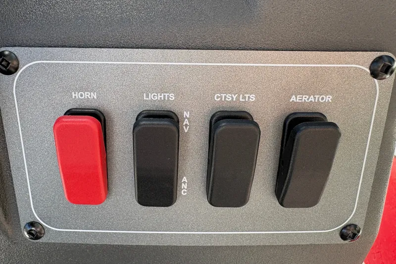 Slide: The Image of Control panel of 2026 Sun Tracker Bass Buggy 16 XL Select with switches for horn, lights, and aerator. - 27