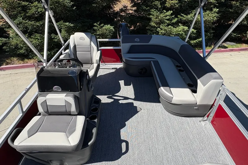 Slide: The Image of 2026 Sun Tracker Bass Buggy 16 XL Select pontoon boat interior with seating and steering console. - 17