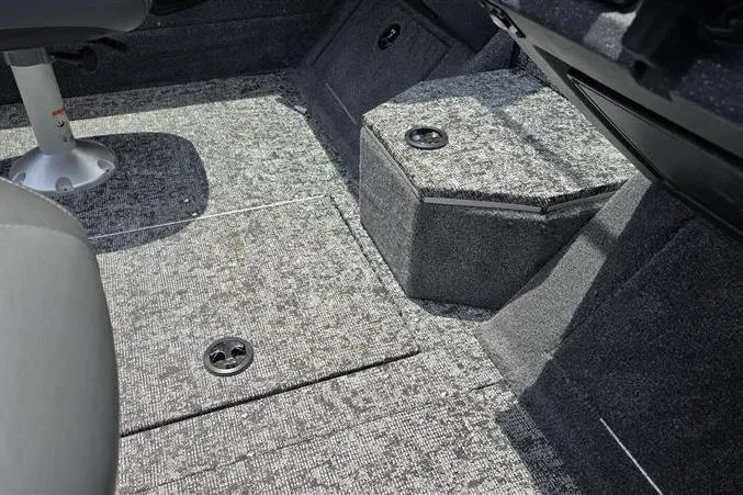 Slide: The Image of Interior view of 2026 Tracker Targa V-18 Combo boat, featuring carpeted flooring and seating. - 12