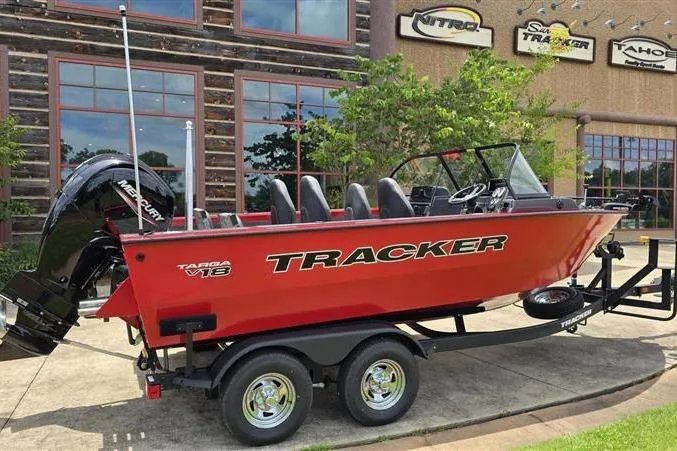Slide: The Image of 2026 Tracker Targa V-18 Combo boat on trailer, red exterior, parked outside dealership. - 6