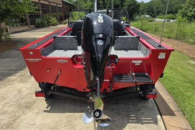 Slide: The Image of 2026 Tracker Targa V-18 Combo boat, red exterior, powerful outboard motor, parked outdoors. - 5