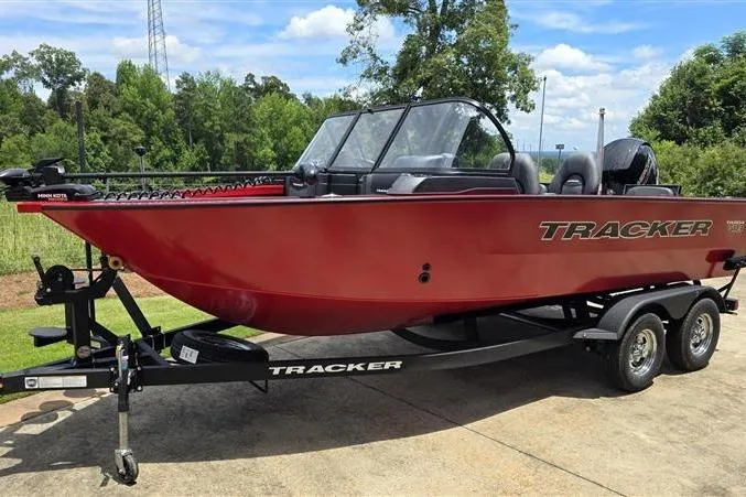 Slide: The Image of 2026 Tracker Targa V-18 Combo boat on trailer, red exterior, parked outdoors. - 3