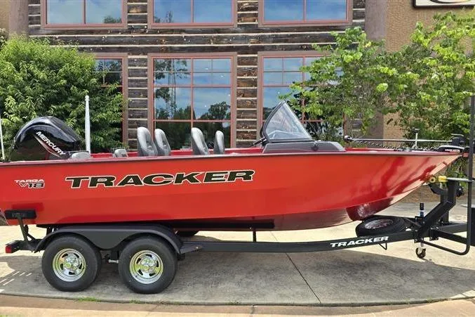 The Image of 2026 Tracker Targa V-18 Combo boat on trailer, red exterior, parked outdoors. - 0